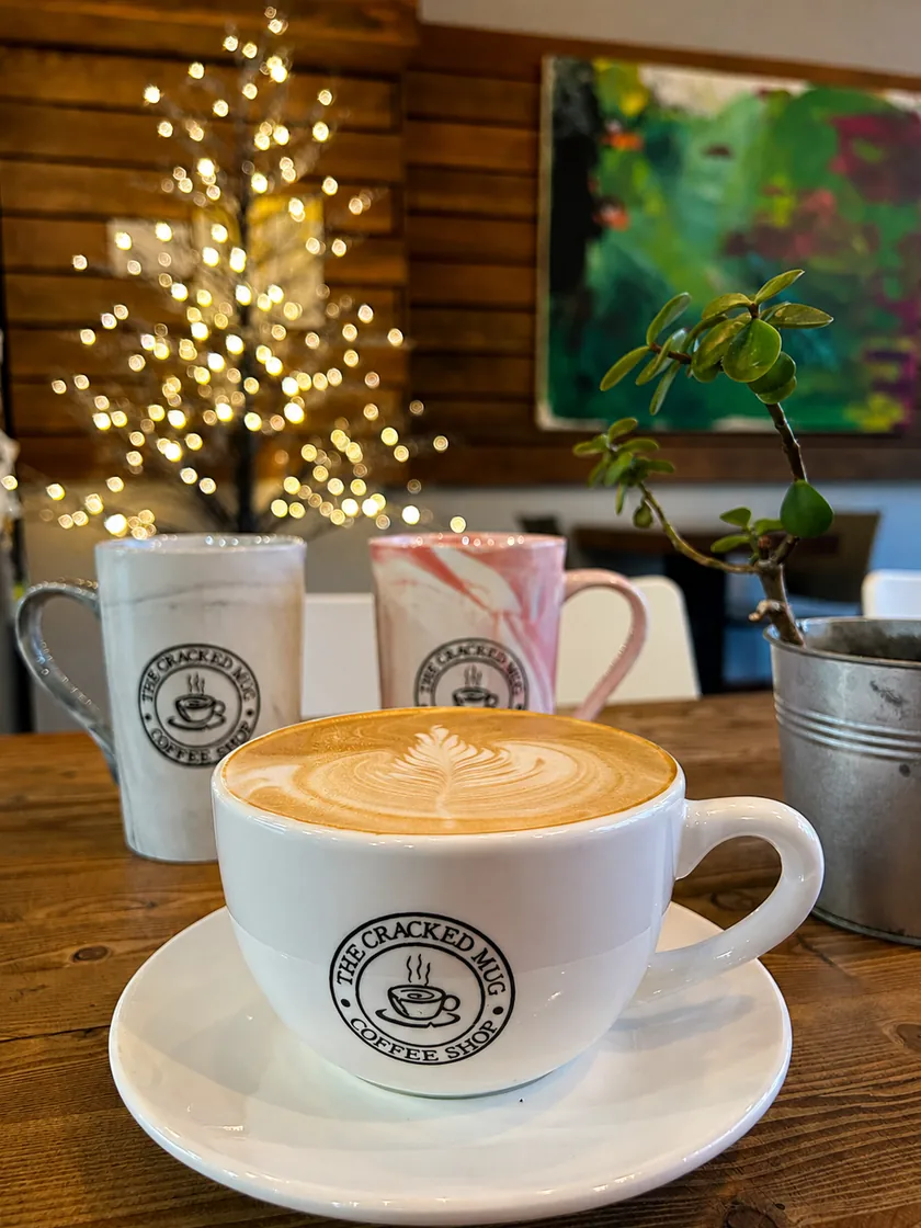 Latte art in a Cracked Mug cup on a wooden table