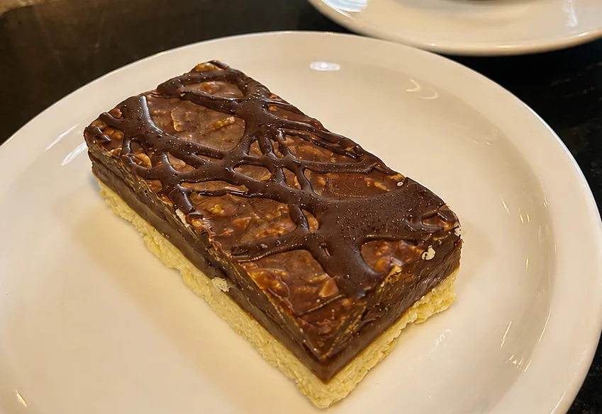 A Millionaire Bar with salted caramel and shortbread on a white plate