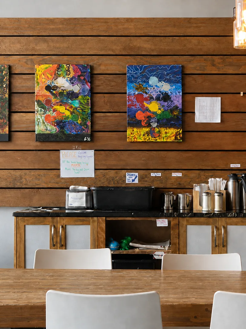 Art on the wooden wall and seating inside The Cracked Mug